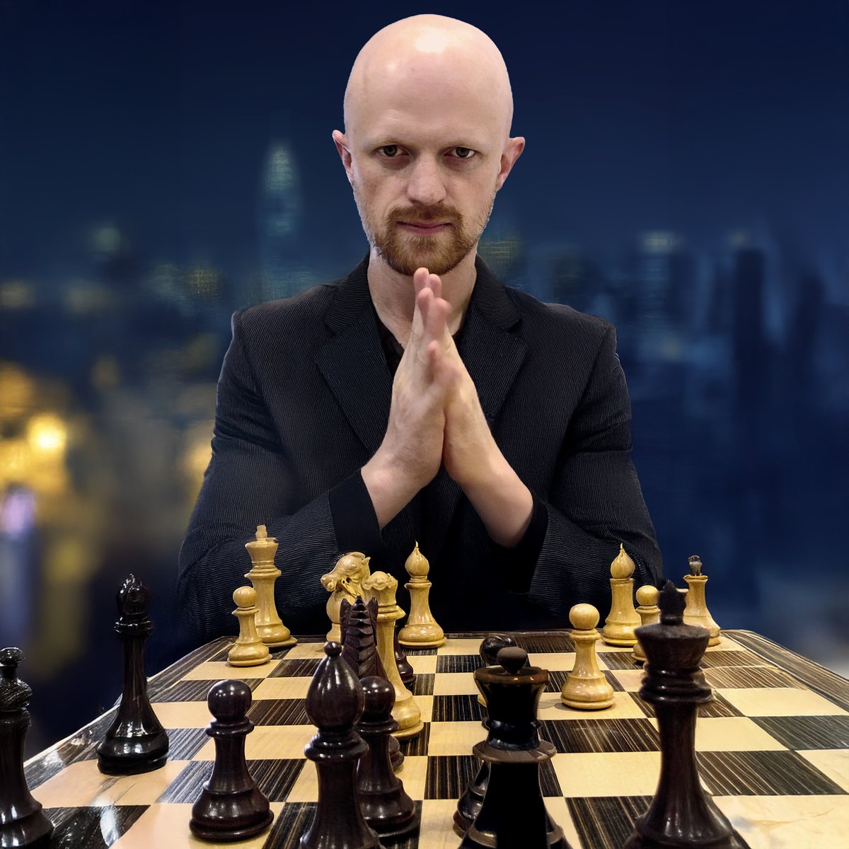 Richard L. Sanders — portrait at the chessboard, dark suit, city skyline